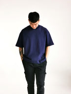 simple hypothesis male model looking down posing with two hands in the pocket